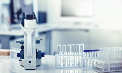Closeup of microscope, test tubes and pipettes or droppers in medical, science or chemistry...