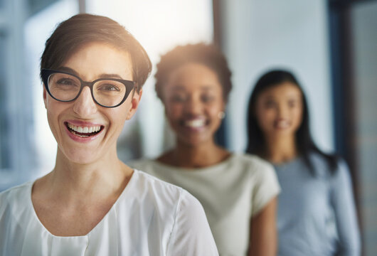 Happy, Professional Business Woman And Hiring Team Welcoming New Recruits And Employees To The Office. Portrait Of Female Leader And HR Manager Smiling With Diverse Colleagues In Background.