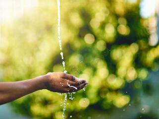 Closeup of hands catching fresh water outdoors, having fun in nature and practicing good hygiene....
