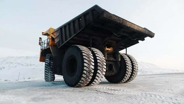 Mining Coal on Quarry and Large Dump Truck in Work. Industrial Concept of Machinery Working on Extraction. Ecology Pollution in Heavy Industry. Big Wheel Tipper Moving on Open-pit. Driving Iron Ore