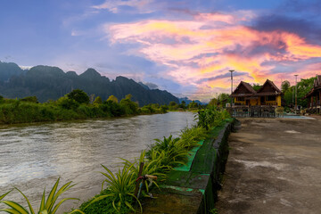 Fototapeta premium Vang Vieng Laos a beautiful city on the river with huge rising mountains and slow flowing river. 