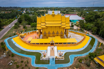 A top view from a drone of the temple building is shaped like a traditional Thai boat at Wat Tha Makok, Rayong, Thailand.