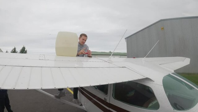 Pilot Refueling Cessna Skyhawk Airplane Before Flight. wide