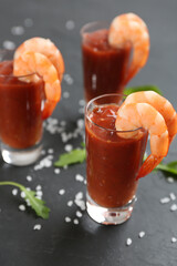 Delicious shrimp cocktail with tomato sauce served on black table