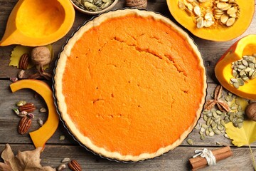 Flat lay composition with delicious homemade pumpkin pie on wooden table