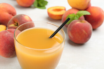 Natural freshly made peach juice on white table, closeup