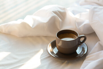 Aromatic morning coffee on bed, space for text