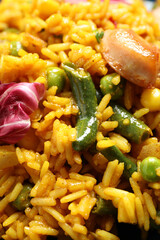 Delicious rice pilaf with chicken and vegetables as background, closeup