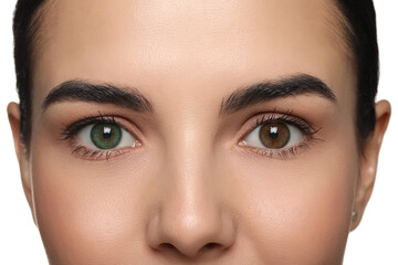 Woman with beautiful eyes of different colors, closeup. Heterochromia iridis