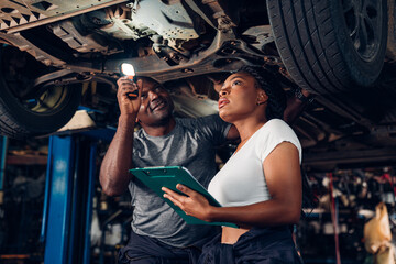 Auto mechanic are checking and repair maintenance auto engine is problems at car repair shop.