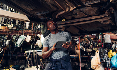 Fototapeta na wymiar Auto mechanic are checking and repair maintenance auto engine is problems at car repair shop.