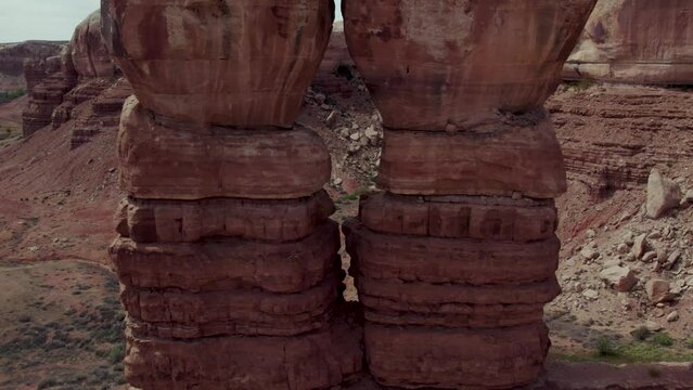 Symmetrical Twin Pair of Towering Cliff Rock Formations in Utah National Park, Aerial Drone Pullaway