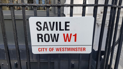 LONDON, UNITED KINGDOM, FEBRUARY 26, 2022 - Savile Row street sign in London, City of Westminster where the Beatles played the last concert, the rooftop concert, on January 30th, 1969 - obrazy, fototapety, plakaty