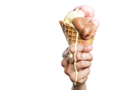 Melting ice cream cone in a hand