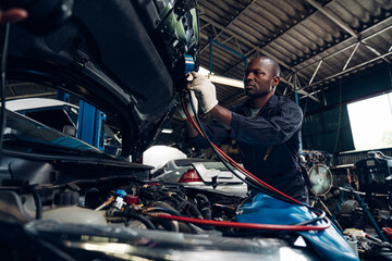 Auto mechanic are  repair and maintenance auto engine is problems at car repair shop.