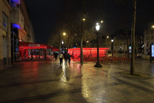 Paris, France - February The 21st, 2022: A Restaurant By Night On Champs-Elysées Avenue.