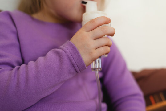 Close-up of a child's hand with a nebulizer