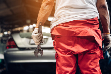 Closeup of Professional Mechanic Repairing Car Engine in Garage, Banner cover design.