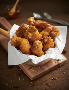 A bowl with crispy golden fried chicken. Korean style with  honey saurce. Selective focus.