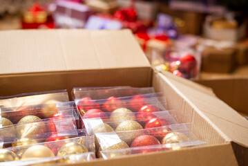 Boxes with Christmas decorations: golden and red baubles for christmas tree. Disassembling...