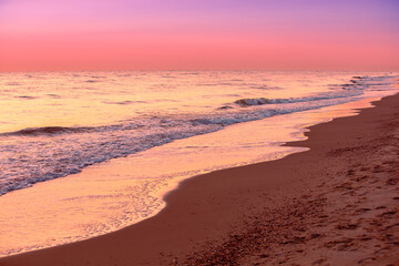 Seascape in the evening. Pink sunset over the sea