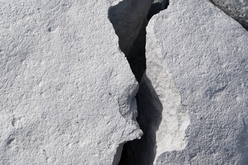 A large rock has cracked into two, it looks like a crevasse