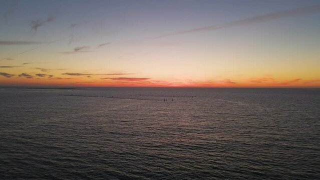 AERIAL - wide angle fly over shot of the ocean just after sunset