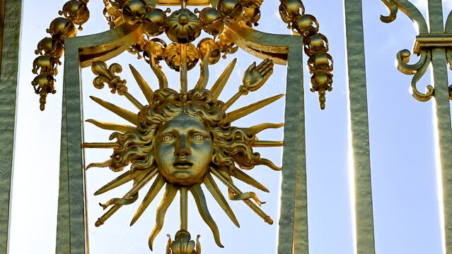 Versailles, Paris, France, June 2022. Detail of the gate of the palace: the golden representation of the king's face expresses all the beauty and splendor of the palace, a symbol of power.