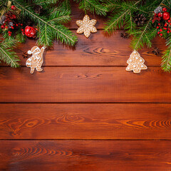 Fototapeta na wymiar Square Christmas background with fir tree and gingerbread. Top view with copy space.