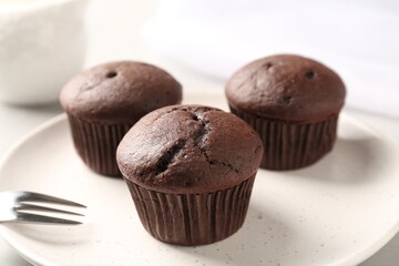Delicious fresh chocolate cupcakes on plate, closeup