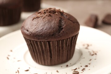 Delicious cupcake with chocolate crumbles on plate, closeup