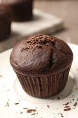 Delicious cupcake with chocolate crumbles on plate, closeup