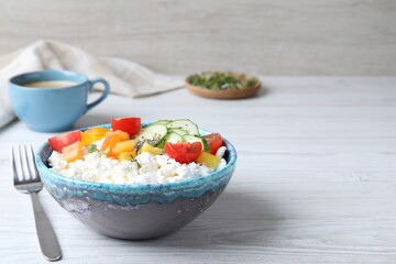 Delicious cottage cheese with vegetables and chia seeds served on white wooden table, space for...