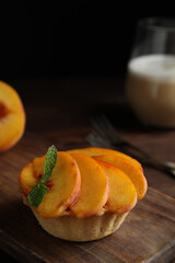 Delicious peach dessert on wooden board, closeup