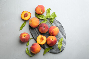 Fresh sweet peaches on light table, flat lay
