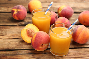 Natural peach juice and fresh fruits on wooden table