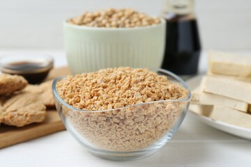 Dried soy meat and other products on white wooden table, closeup