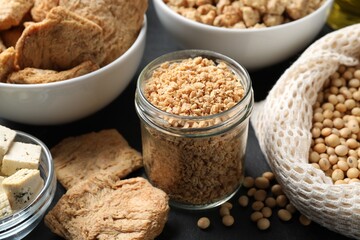 Different organic soy products on black table, closeup