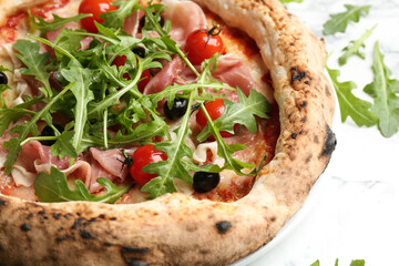 Tasty pizza with meat and arugula on white table, closeup