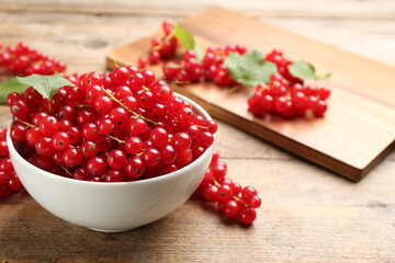 Delicious red currants on wooden table. Space for text