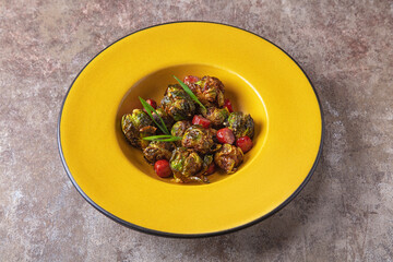 Fried broccoli with sausages and onions