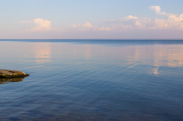 Sea coast with calm water sunset