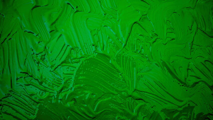 Neon green acrylic or oil paint texture. Closeup of the brush stroke paint. Colorful abstract painting background