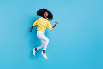 Fototapeta na wymiar Full length photo of young happy girl running fly going shopping have free time isolated on blue color background