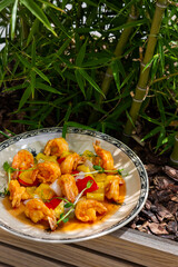 Salad with fried shrimps in batter with tomatoes, onions, sauce, pea sprouts and pepper