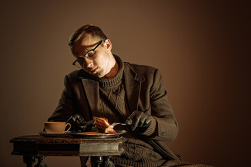 Retro style portrait of young man, writer and traveler wearing vintage style clothes isolated over...