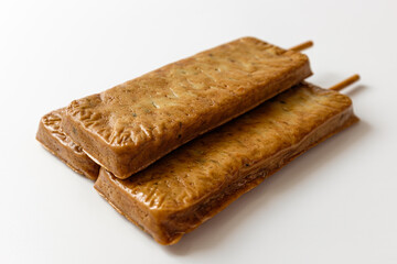 fish cake skewers on a white background