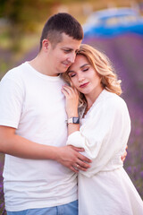 Young couple in love bride and groom, wedding day in summer. Enjoy a moment of happiness and love in a lavender field.