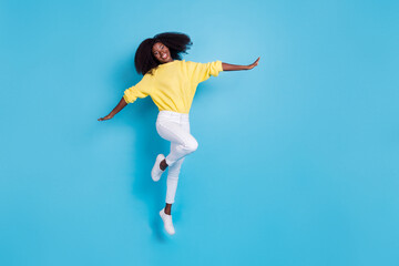 Fototapeta na wymiar Full length body size photo of young girl simulating airplane flying relax isolated on blue color background