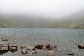 Cader Idris mountain with lake near the town of Dolgellau, in National Park Snowdonia in Wales, misty morning 2022.